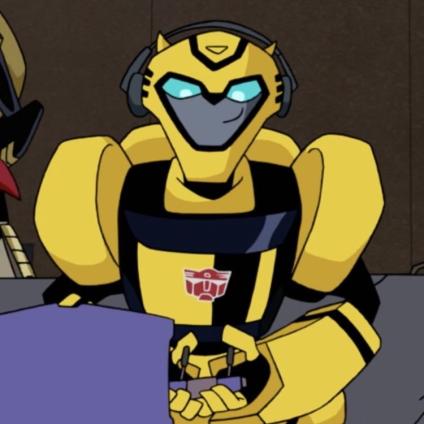image of transformers animated bumblebee wearing a headset and holding a game controller with a smirk on his face